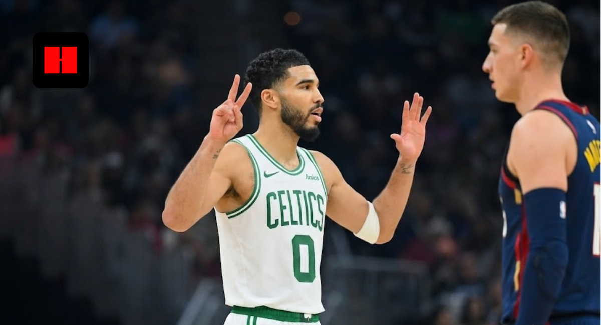 Jayson Tatum in a white Boston Celtics jersey signaling with his hands during an NBA game.