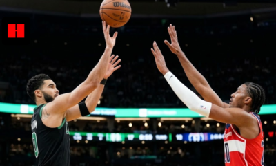 Boston Celtics forward Jayson Tatum shooting a jump shot over Washington Wizards defender Alex Sarr during an NBA game.