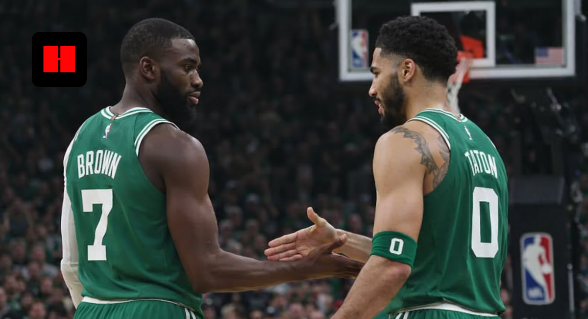 Jayson Tatum and Jaylen Brown of the Boston Celtics during an on-court handshake in an NBA game.