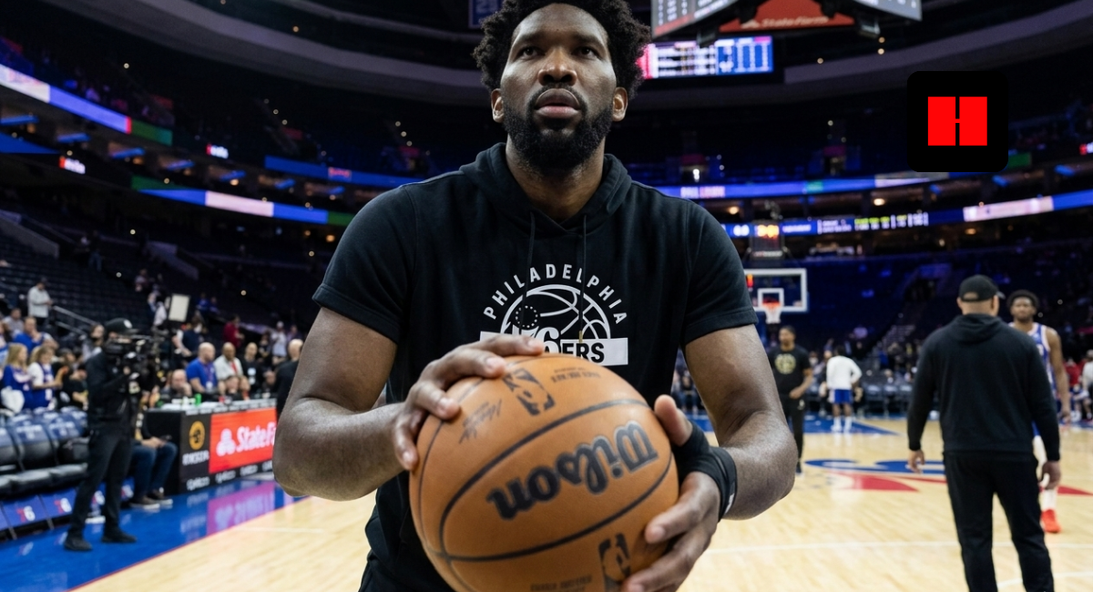 Joel Embiid warming up with a basketball on the Philadelphia 76ers home court before a game, wearing team gear inside the arena in 2026