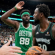 Julius Randle of the Minnesota Timberwolves looking to pass while guarded by Neemias Queta of the Boston Celtics during an NBA game.