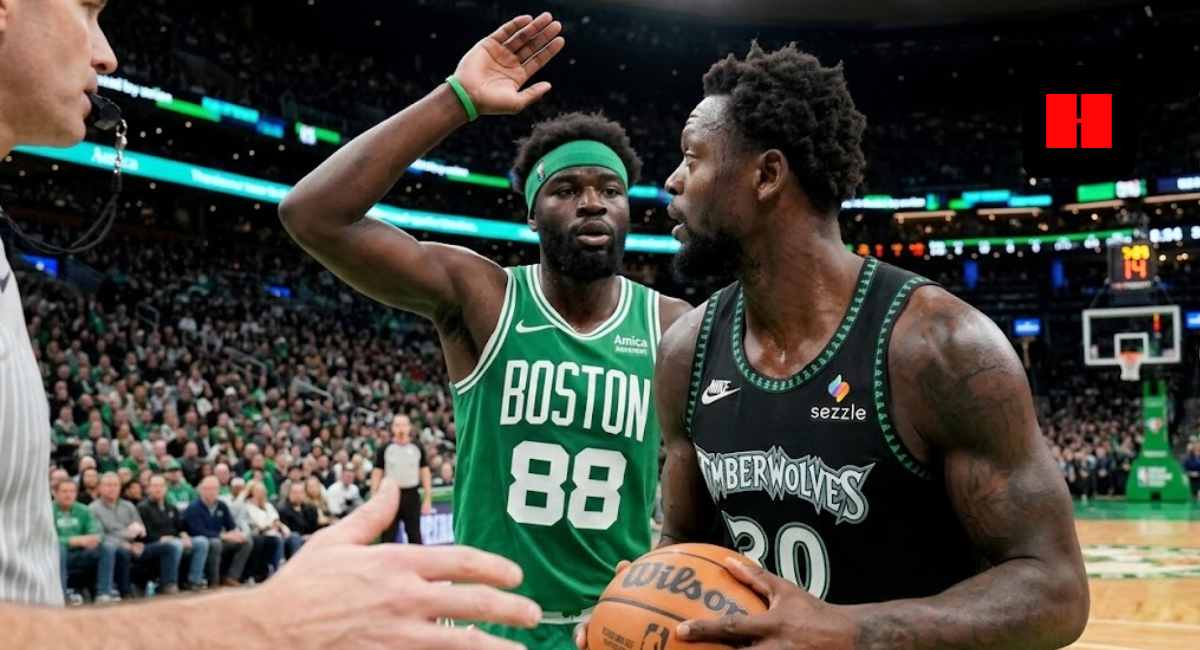Julius Randle of the Minnesota Timberwolves looking to pass while guarded by Neemias Queta of the Boston Celtics during an NBA game.