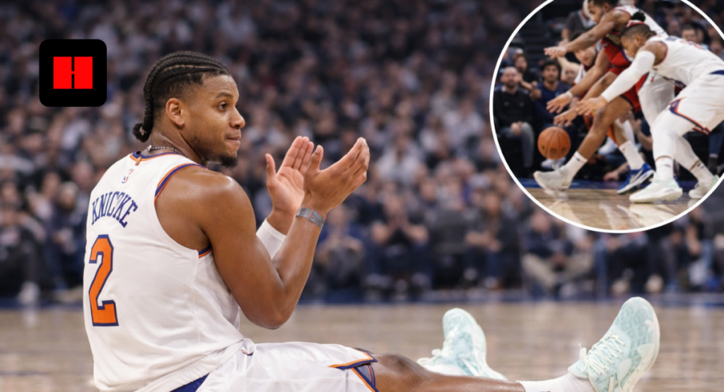 New York Knicks player sitting on the court during an NBA game after a physical play