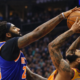 New York Knicks player blocks a Phoenix Suns player during an intense NBA game action shot near the basket