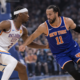 New York Knicks player driving to the basket against Oklahoma City Thunder defender during NBA game