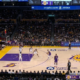 Wide shot of Lakers vs Nets game at Crypto.com Arena with Los Angeles on offense and Brooklyn set on defense during first quarter action.