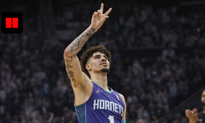 LaMelo Ball of the Charlotte Hornets making a victory gesture during an NBA basketball game in a packed arena