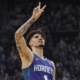 LaMelo Ball of the Charlotte Hornets making a victory gesture during an NBA basketball game in a packed arena