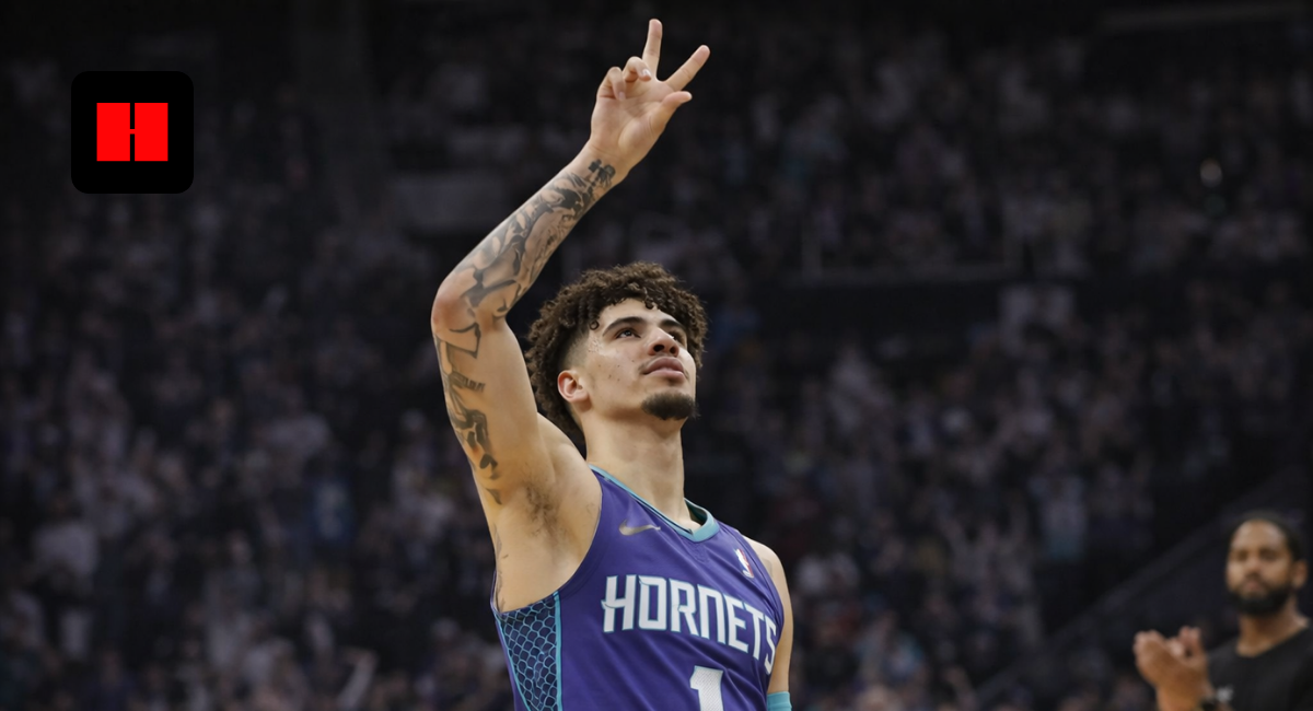 LaMelo Ball of the Charlotte Hornets making a victory gesture during an NBA basketball game in a packed arena