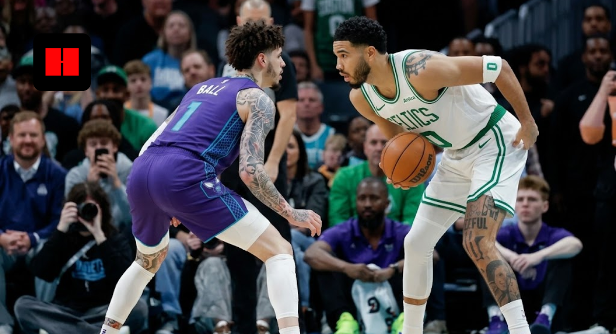 LaMelo Ball in a purple Charlotte Hornets jersey playing tight defense against Jayson Tatum of the Boston Celtics during an NBA game.