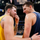 Luka Dončić and Nikola Jokić share a postgame moment on court during an NBA game break