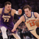 Luka Doncic driving past New York Knicks defender during NBA game action on court