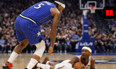 Orlando Magic guard Markelle Fultz defends as Oklahoma City Thunder's Shai Gilgeous-Alexander dives for a loose ball during an NBA game