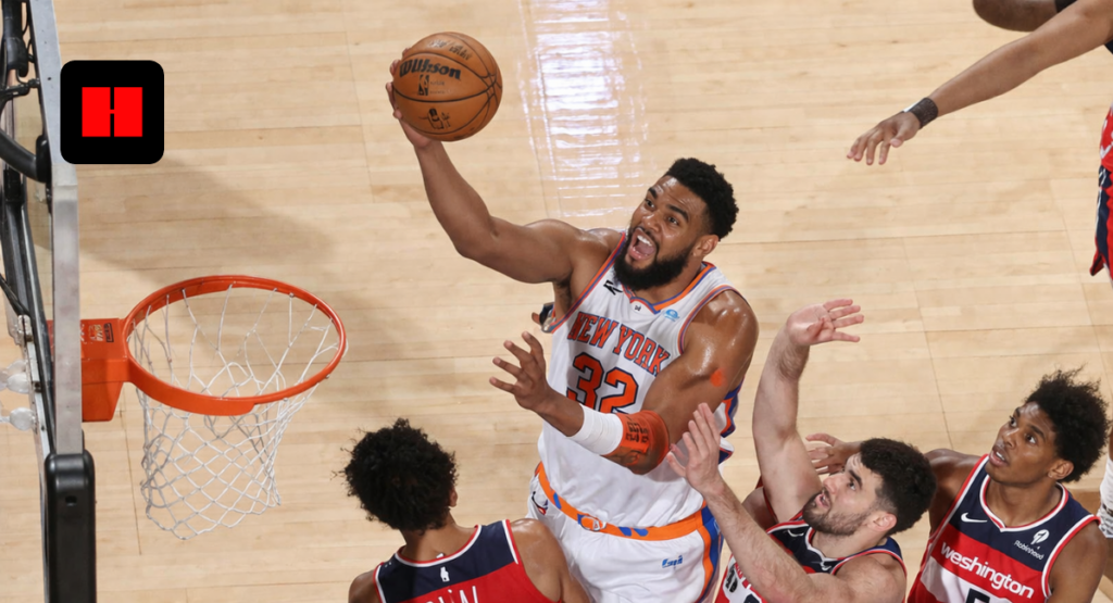 NBA player attempting layup in the paint defended by multiple Washington Wizards players during game action