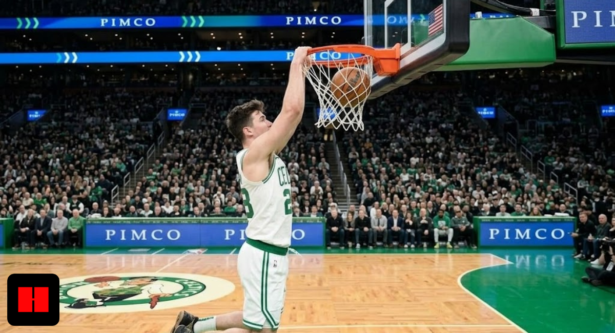 Boston Celtics center Neemias Queta performing a powerful one-handed slam dunk during an NBA game at TD Garden, side view.