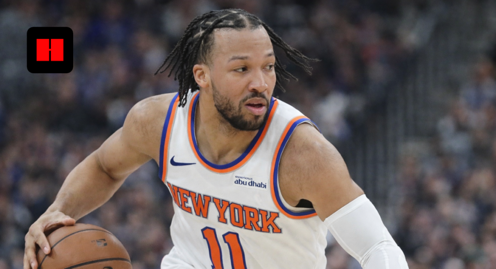 New York Knicks guard dribbling the basketball during an NBA game while wearing white Knicks jersey number 11
