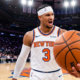 New York Knicks player Josh Hart in a white home jersey and headband, showing intense emotion during a game at MSG.