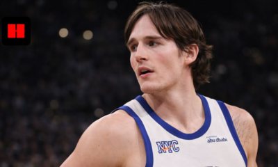 Close-up of New York Knicks player looking sideways during NBA game with focused expression and blurred arena crowd in background