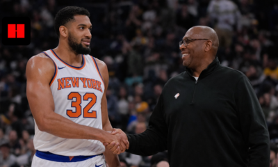 New York Knicks player standing with coach courtside during an NBA basketball game