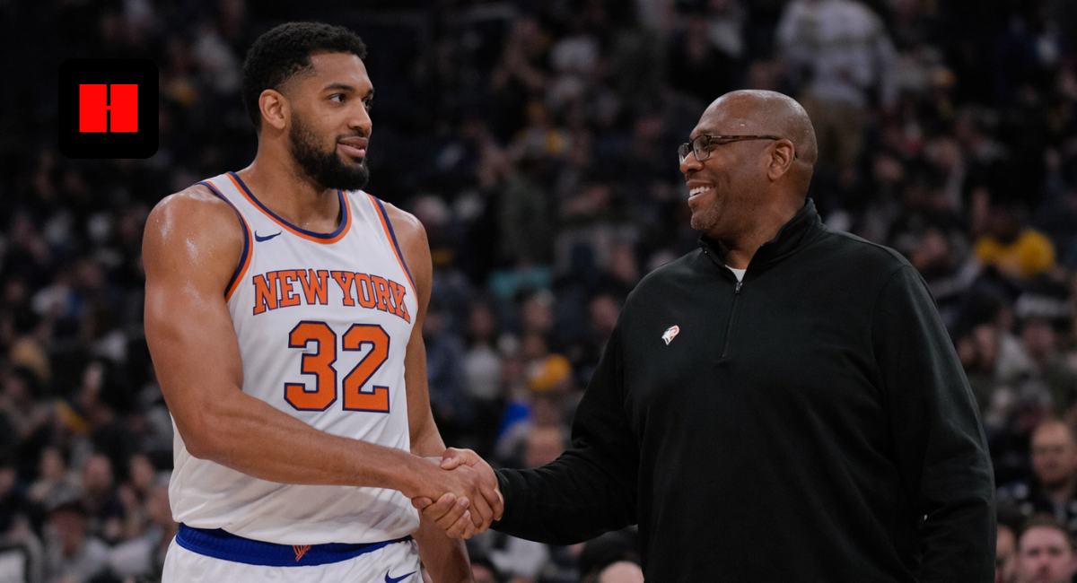 New York Knicks player standing with coach courtside during an NBA basketball game