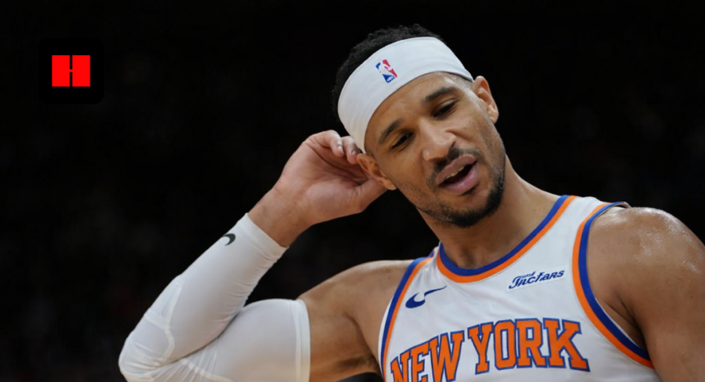 Close-up of a New York Knicks basketball player wearing a headband during an NBA game, looking thoughtful on the court