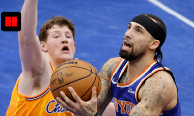 New York Knicks player attempting a layup against Charlotte Hornets defender during an NBA game