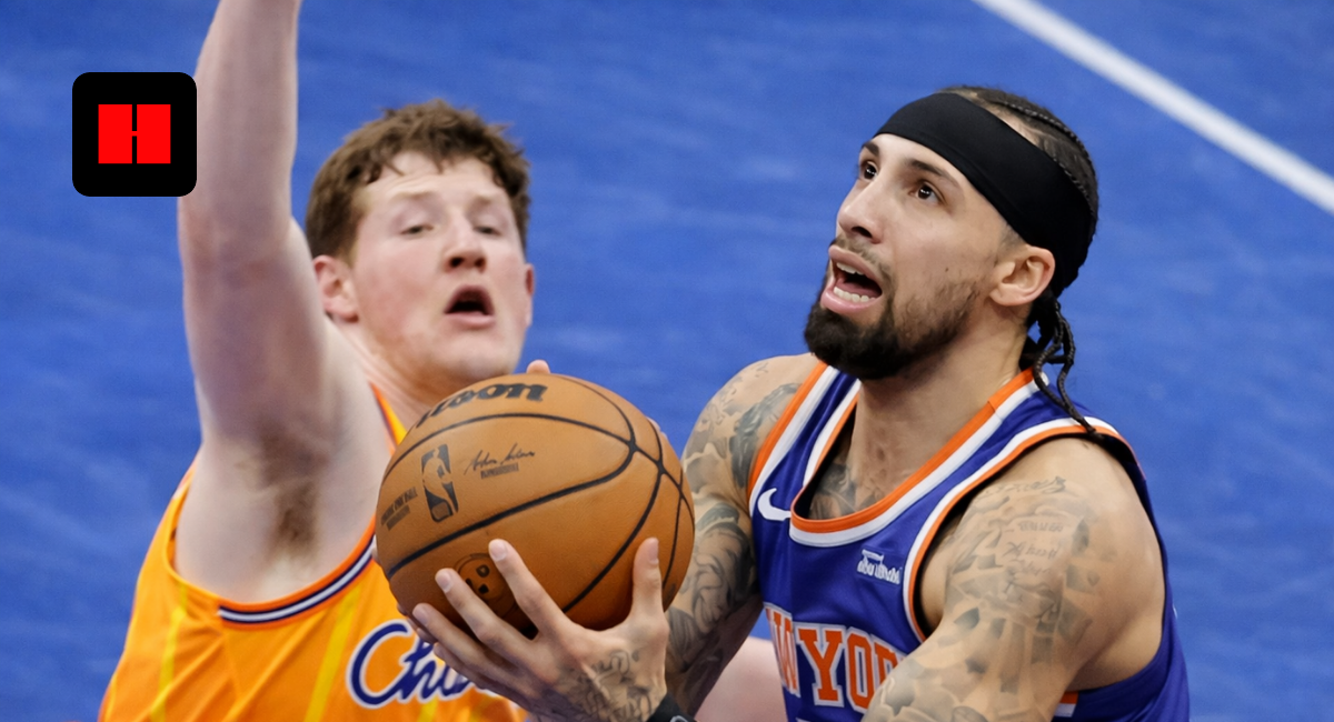 New York Knicks player attempting a layup against Charlotte Hornets defender during an NBA game