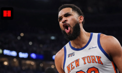 New York Knicks basketball player showing intense reaction during an NBA game with crowd and arena lights in the background