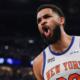 New York Knicks basketball player showing intense reaction during an NBA game with crowd and arena lights in the background