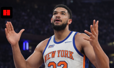 New York Knicks player showing emotional reaction with raised hands during live NBA game in arena captured