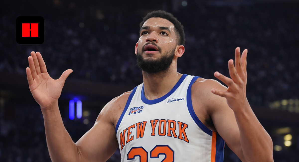 New York Knicks player showing emotional reaction with raised hands during live NBA game in arena captured