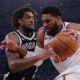 New York Knicks player driving past Brooklyn Nets defender during NBA game action in UHD quality