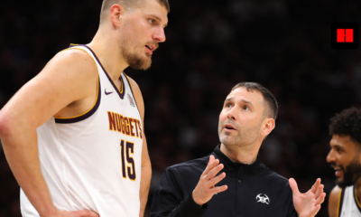 Nikola Jokic listens to Nuggets coach David Adelman during in-game sideline discussion