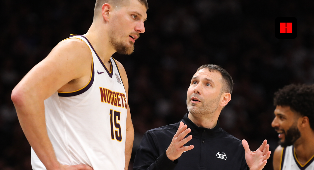 Nikola Jokic listens to Nuggets coach David Adelman during in-game sideline discussion