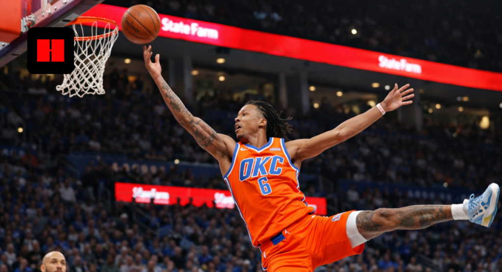 Oklahoma City Thunder player performing an acrobatic dunk layup in mid-air during an NBA game with defenders and crowd in a packed arena
