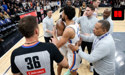 Oklahoma City Thunder's Chet Holmgren and Shai Gilgeous-Alexander being held back by officials and coaches during an intense NBA game moment.