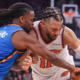 Oklahoma City Thunder player defends New York Knicks player during an intense NBA basketball game action shot