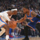 Oklahoma City Thunder player dribbling against New York Knicks defender during an NBA basketball game