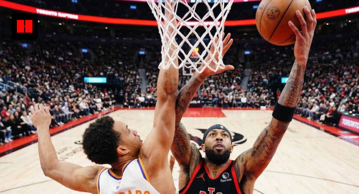 Phoenix Suns Oso Ighodaro defending a layup by a Toronto Raptors player during an NBA game at Scotiabank Arena.