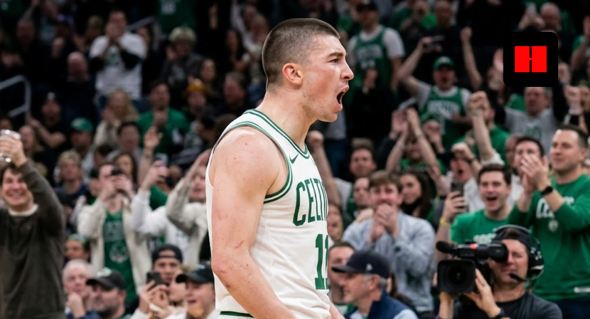 Boston Celtics guard Payton Pritchard shouting in celebration during a home game at TD Garden, side profile view.