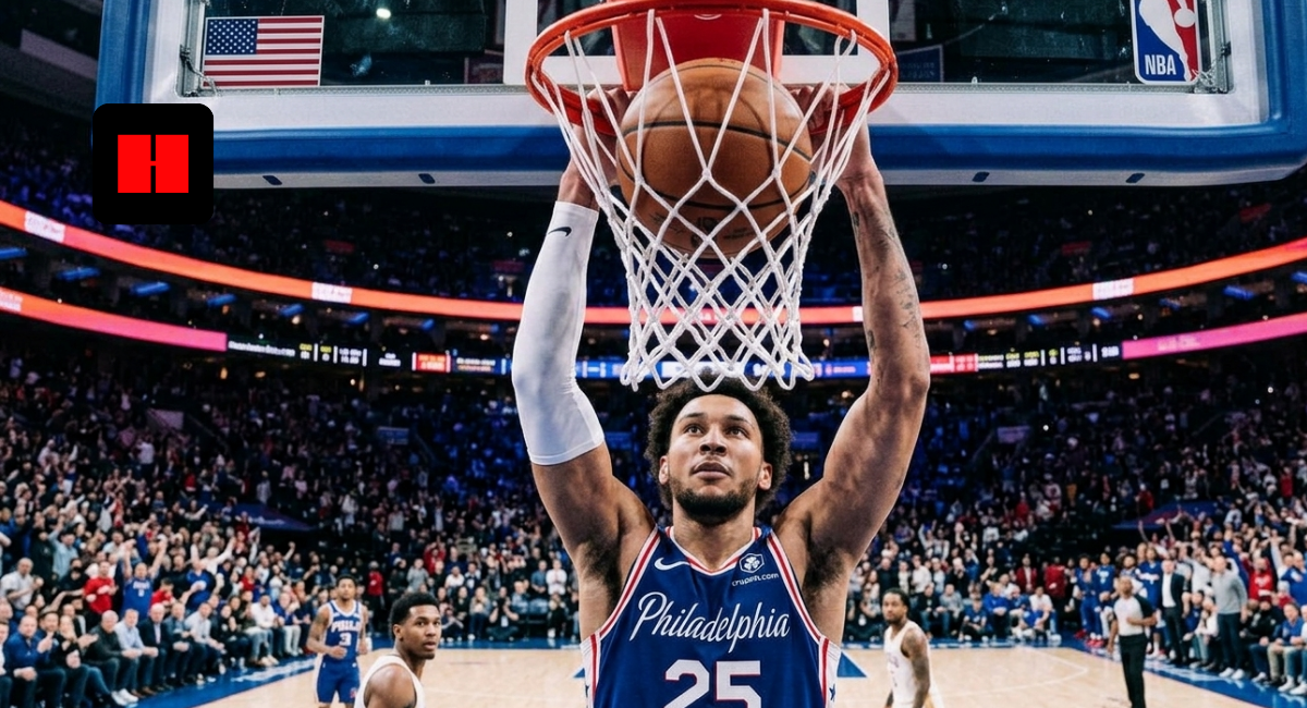Philadelphia 76ers player finishes a powerful dunk during an NBA game at Xfinity Mobile Arena with the crowd reacting in the background.