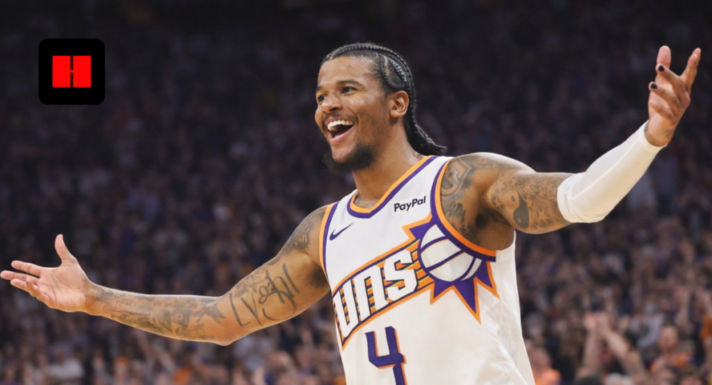 Phoenix Suns player celebrating with arms outstretched during an NBA game on the court