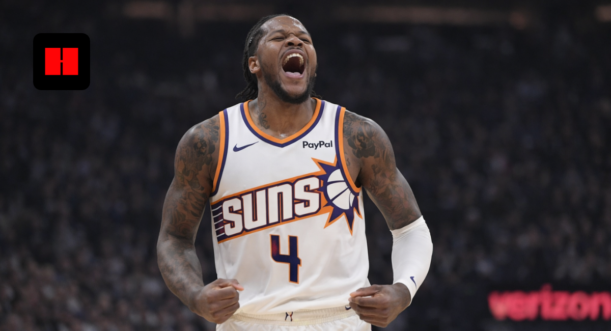 Phoenix Suns player celebrating passionately during an NBA game in a white home jersey