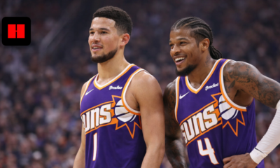 "Phoenix Suns basketball players standing on court during game in UHD quality, wearing purple jerseys with crowd background"