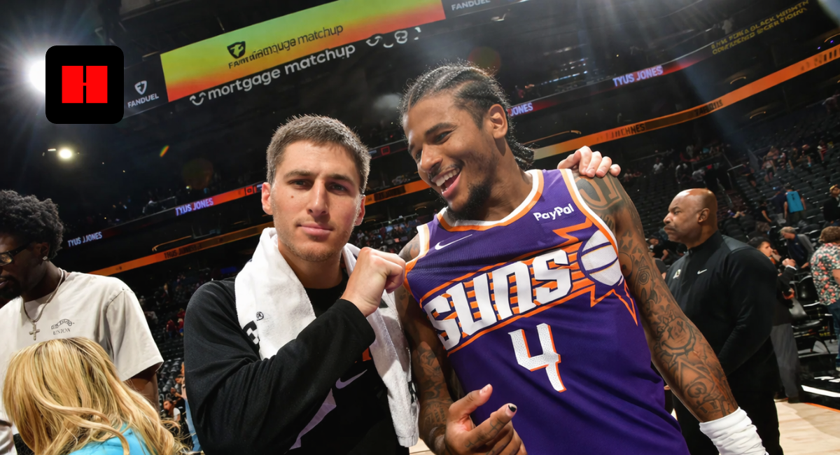 Phoenix Suns players smiling after game on basketball court with fans in arena UHD