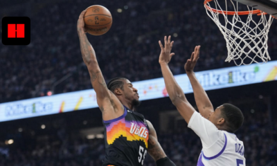 Phoenix Suns player attempting a layup over Utah Jazz defender during an NBA game action shot