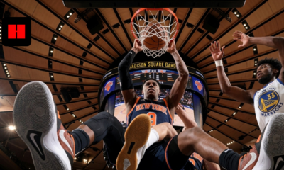 RJ Barrett of the New York Knicks dunks over James Wiseman of the Golden State Warriors at Madison Square Garden.