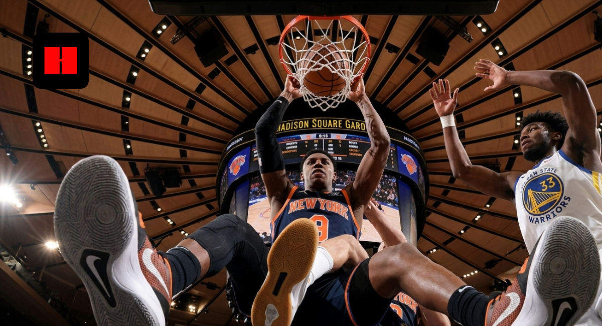 RJ Barrett of the New York Knicks dunks over James Wiseman of the Golden State Warriors at Madison Square Garden.