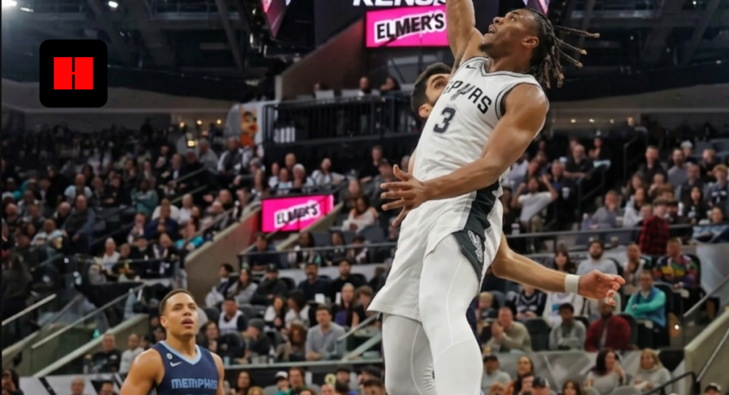A San Antonio Spurs player in a white jersey performs a powerful one-handed dunk against the Memphis Grizzlies in a crowded NBA arena.