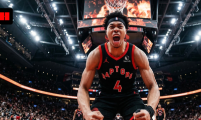 Toronto Raptors player Scottie Barnes shouting in celebration on the basketball court, low-angle action shot with arena crowd in background.